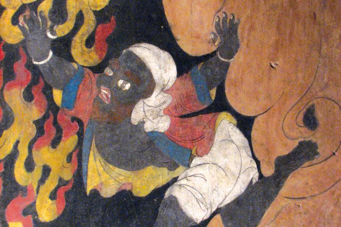 On one of the walls, a large halo of flame is left empty. Interspersed in the empty halo, however, are black birds, black dogs, and black skinned people, the iconographic retinue of Gur Gönpo, the principle protector of the Sakyapa tradition. a black figure from the empty halo of flames, suggesting a representation of Panjarnatha Mahakala